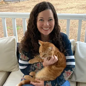 Kate the Cat Sitter holding one of her own cats, Myles